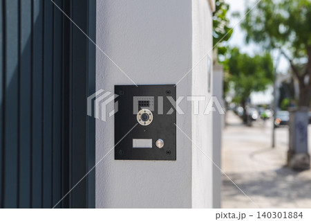 Modern video intercom system installed on residential building entrance wall, smart home access control technology with doorbell camera Modern video intercom system installed on residential building entrance wall, smart home access control technology with doorbell camera 140301884