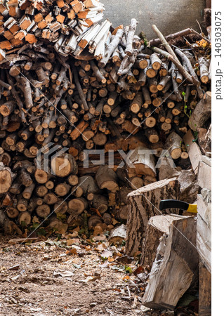 stack of firewood from sawn trees in village barn stack of firewood from sawn trees in village barn 140303075