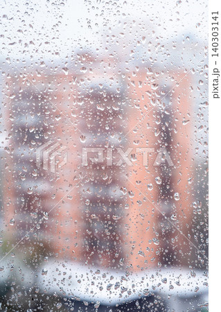 water drops on home window and blured house water drops on home window and blured house 140303141