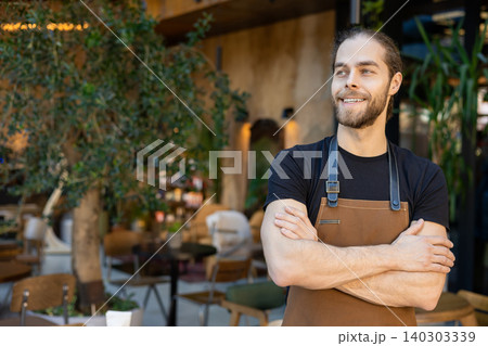 Professional waiter standing with crossed arms Professional waiter standing with crossed arms 140303339