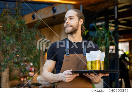 Confident server holding tray with napkins Confident server holding tray with napkins 140303345
