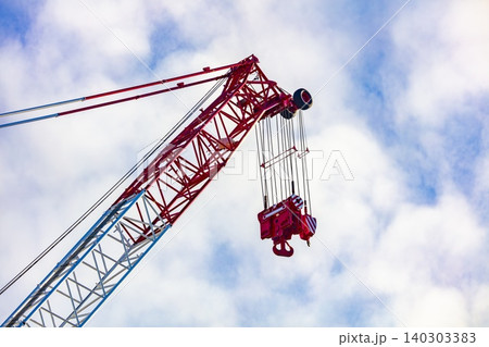 The top section of a large industrial crane on a construction site The top section of a large industrial crane on a construction site 140303383