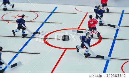 Tabletop Hockey Game with Players in Action Tabletop Hockey Game with Players in Action 140303542