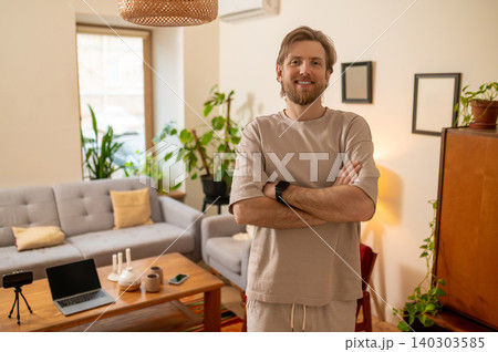Fair-haired bearded man standing in the middle of the room and looking confident and resolute 140303585