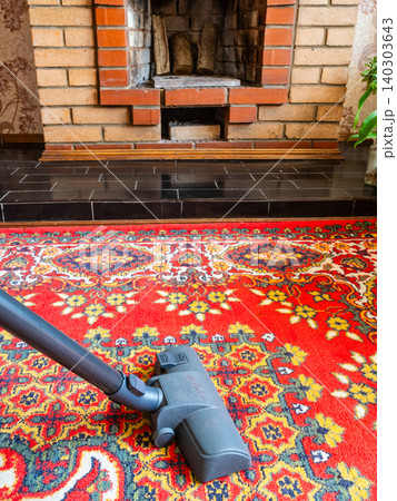 vacuum cleaner cleans carpet near fireplace vacuum cleaner cleans carpet near fireplace 140303643