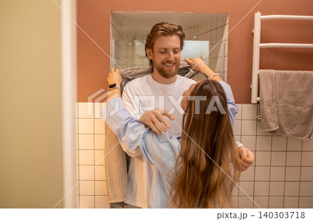 Young couple having morning procedures and having fun feeling happy and joyful Young couple having morning procedures and having fun feeling happy and joyful 140303718