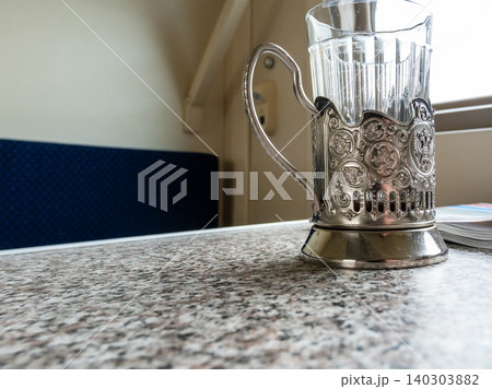glass in cup holder close up on table in train 140303882