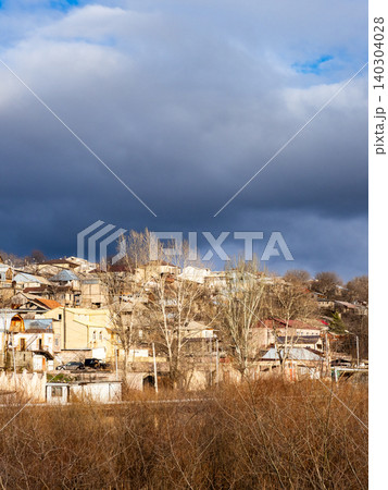 gray cloud over sunlit urban houses in Vanadzor gray cloud over sunlit urban houses in Vanadzor 140304028