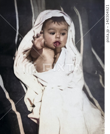 Vintage baby drinking from a bottle in a retro childhood care scene Vintage baby drinking from a bottle in a retro childhood care scene 140304921