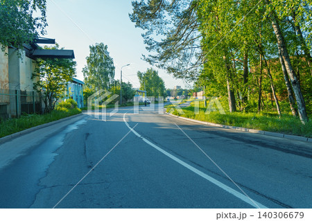 Quiet tree-lined suburban street with morning light Quiet tree-lined suburban street with morning light 140306679