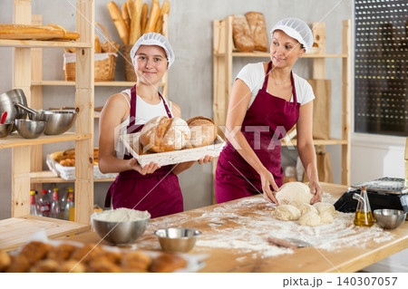 Women bakers making bread in a bakery Women bakers making bread in a bakery 140307057