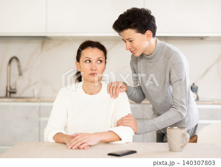 Son trying to apologize to his offended mother after home disagreements 140307803