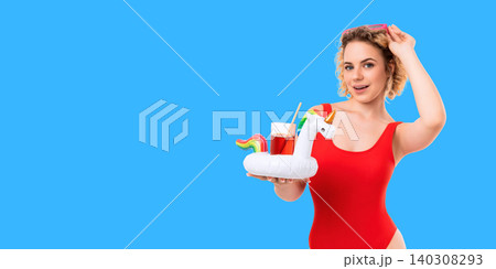 Woman poses confidently in red swimsuit holding drink. Summer concept filled with vibrant fun Woman poses confidently in red swimsuit holding drink. Summer concept filled with vibrant fun 140308293