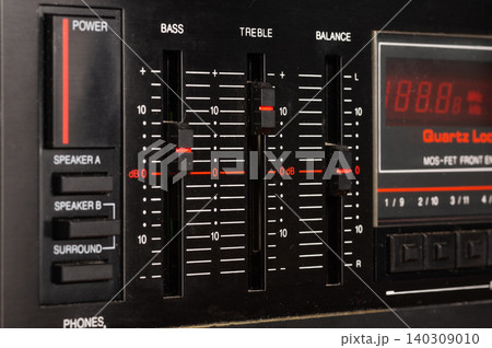 Close-up of volume and tone controls on an audio amplifier. 140309010