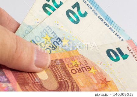 Close-up of 20 and 10 Euro banknotes in hand 140309015
