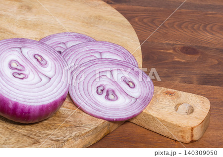 Close-up of sliced red onion on a wooden background Close-up of sliced red onion on a wooden background 140309050