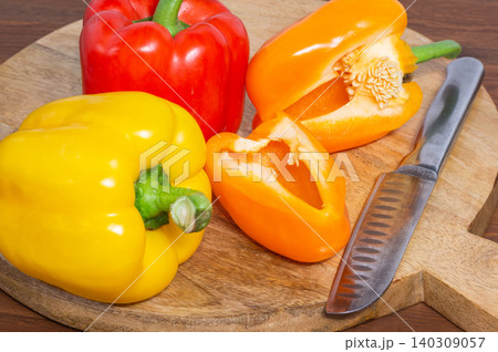 Close-up of a cut sweet pepper on a wooden background. Close-up of a cut sweet pepper on a wooden background. 140309057