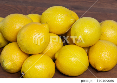 Close-up of many lemons on a wooden background 140309060
