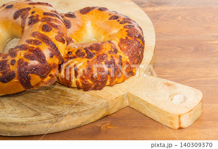 Close-up cheese bagel in wood Close-up cheese bagel in wood 140309370