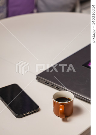 Coffee break at home while working on a laptop and thinking about tasks Coffee break at home while working on a laptop and thinking about tasks 140310314