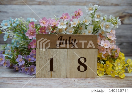 Wooden Calendar Showing the Date of July 18th. Day 18 of July month Wooden Calendar Showing the Date of July 18th. Day 18 of July month 140310754