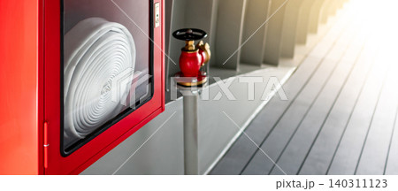 Red fire hose reel cabinet and fire hydrant installed beside the corridor Red fire hose reel cabinet and fire hydrant installed beside the corridor 140311123