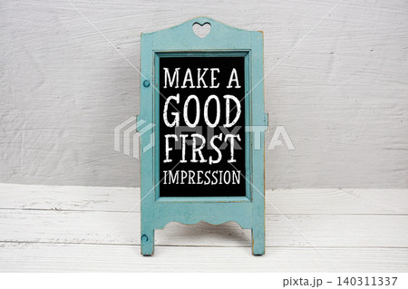 Make A Good First Impression text written on wooden blue easel 140311337