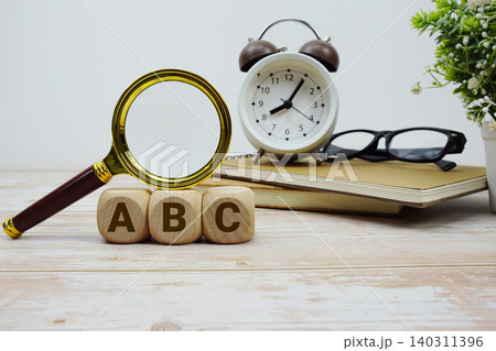 ABC Always Be Closing alphabet letters with magnifying glass and alarm clock 140311396