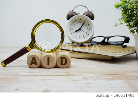 AID Audit Information System alphabet letters with magnifying glass and alarm clock 140311405