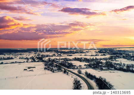Aerial evening view at countryside and snowy fields during sunset 140313695