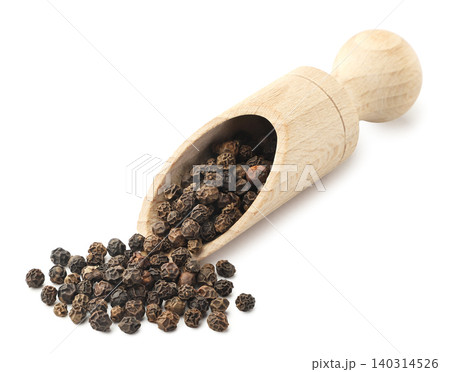 Black peppercorns spilling from a wooden spatula on a white background. Isolated Black peppercorns spilling from a wooden spatula on a white background. Isolated 140314526