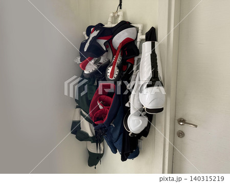 Sport gear and shoes hanging on a wall in a hallway during a busy day of training at sports facility Sport gear and shoes hanging on a wall in a hallway during a busy day of training at sports facility 140315219