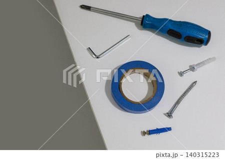 Several tools are spread out on a plain white surface. Several tools are spread out on a plain white surface. 140315223