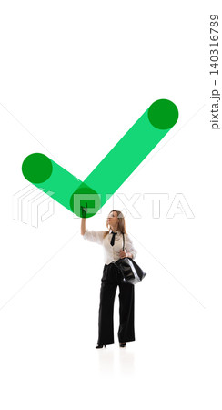 Businesswoman touching large green check mark in clean abstract scene. Businesswoman touching large green check mark in clean abstract scene. 140316789