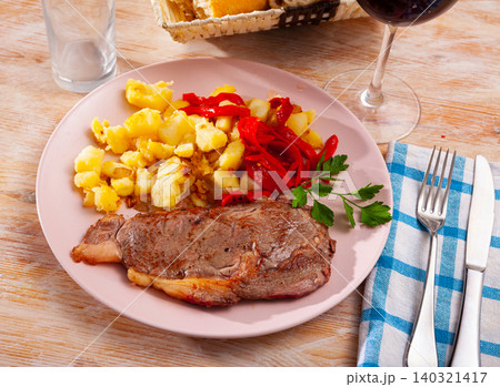 Tasty veal baked with potatoes and peppers served at plate Tasty veal baked with potatoes and peppers served at plate 140321417