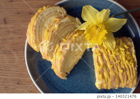 Slices of lemon meringue pie roll on a blue plate 140321476