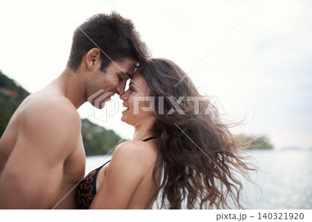 Couple, forehead touch and travel to ocean on vacation, love and relax by water on holiday. People, swimwear and bonding for relationship in outdoors, support and smile on trip to sea or nature Couple, forehead touch and travel to ocean on vacation, love and relax by water on holiday. People, swimwear and bonding for relationship in outdoors, support and smile on trip to sea or nature 140321920