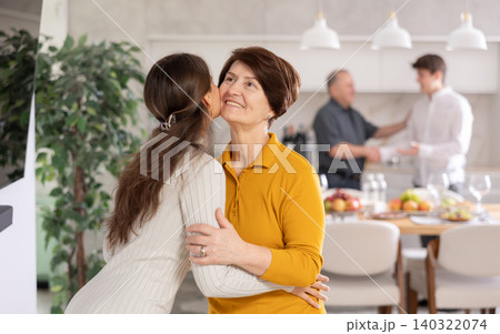 Friendly mother-in-law greeting visiting daughter-in-law with kiss Friendly mother-in-law greeting visiting daughter-in-law with kiss 140322074