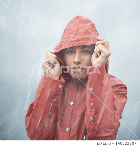 Woman, protection and portrait with rain, coat and clouds with safety in nature. Girll, face and storm with cloudy, winter and waterproof hat for confidence and weather with adventure or vacation 140322207