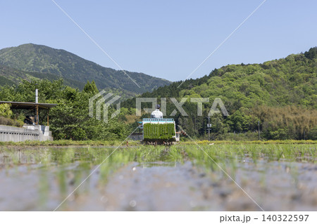 ローアングルで捉えた田植え機と緑豊かな山の背景 ローアングルで捉えた田植え機と緑豊かな山の背景 140322597