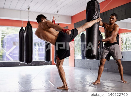 MMA, kickboxing and man coaching as personal trainer in gym, sport and practice with warrior. People, fitness and workout for challenge, exercise and person healthy for competition as fighter 140322760