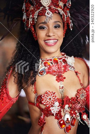 Dancer, carnival and girl in portrait with smile, pride or culture with glow for street performance in night. Person, fashion and woman at event, party or celebration with tradition in Rio de Janeiro 140322920