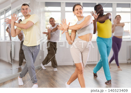 European girl with team of like-minded multinational people learn to elements of electro dance European girl with team of like-minded multinational people learn to elements of electro dance 140323409