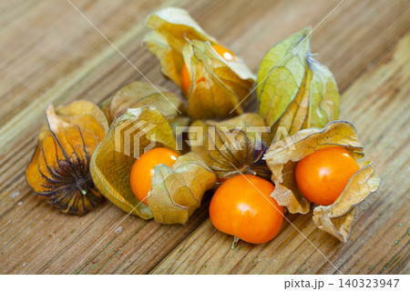 Orange physalis fruit on wooden desk Orange physalis fruit on wooden desk 140323947