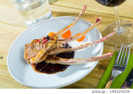 Baked lamb rack of ribs with carrots and sauce 140324256