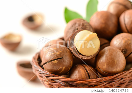 Close-Up of Macadamia Nuts in Wicker Basket with Cracked Shell and Fresh Kernel Close-Up of Macadamia Nuts in Wicker Basket with Cracked Shell and Fresh Kernel 140324733