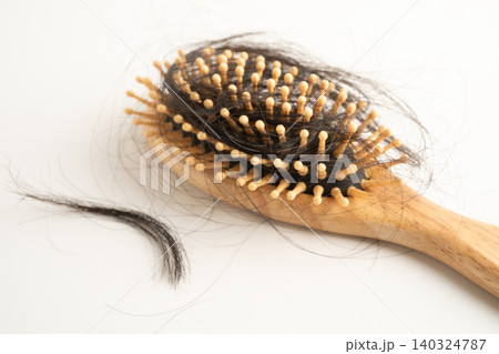 Hair loss fall with comb brush isolated on white background. Hair loss fall with comb brush isolated on white background. 140324787