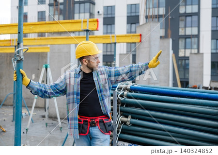 Construction worker wearing hard hat and safety glasses 140324852