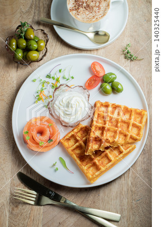 Crunchy waffle fries with sour cream dip served in a basket Crunchy waffle fries with sour cream dip served in a basket 140325440