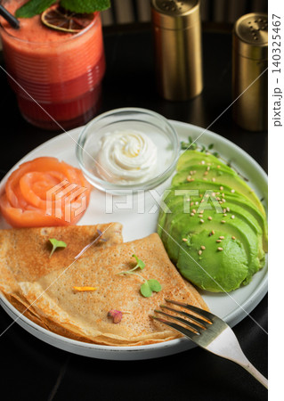 Roasted thin pancakes with smoked salmon and sauce Roasted thin pancakes with smoked salmon and sauce 140325467